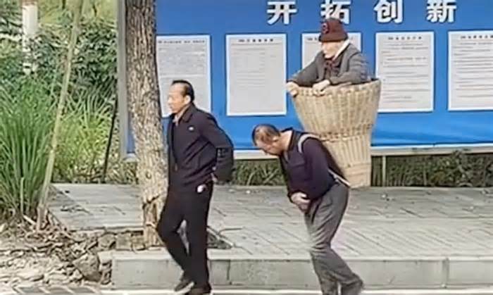 Cảnh hai anh em địu mẹ già đi viện gây sốt mạng ở Trung Quốc